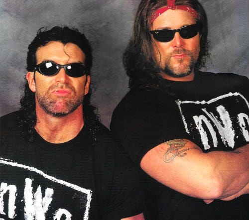 The Outsiders: Scott Hall and Kevin Nash Pinup Poster - WCW Magazine [Spring 1997]Hall and Nash, wearing the original New World Order shirts that they had before they mass produced them. Simple nWo lettering, no “new world order” logo to be found.