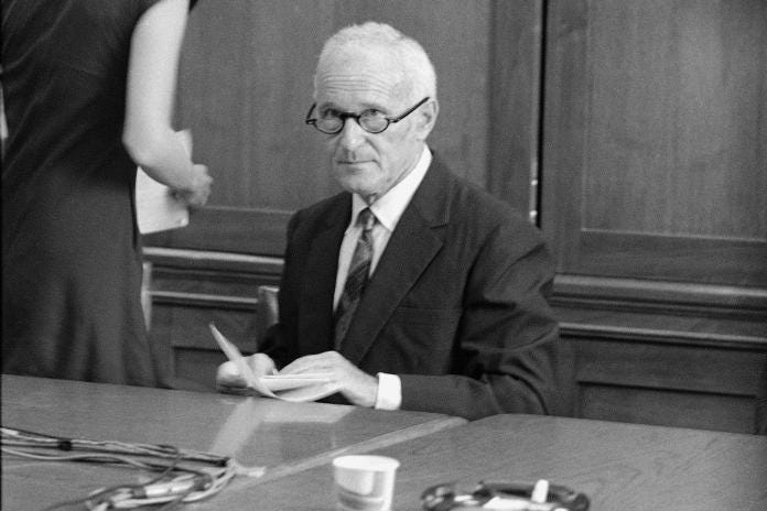 A person in a suit and tie sitting at a table
AI-generated content may be incorrect. A person in a suit and tie sitting at a table
AI-generated content may be incorrect.