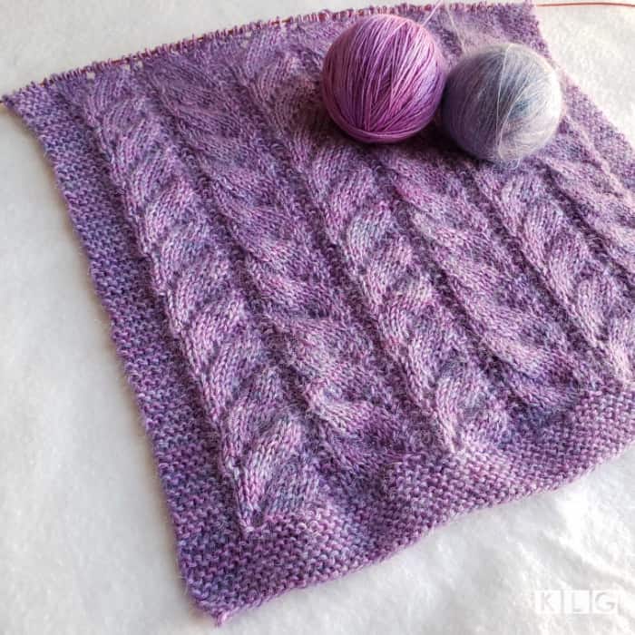 Progress of my Chasing Light Shawl in Rosehip Island Merino Silk and Mohair Silk yarns in purples and blues