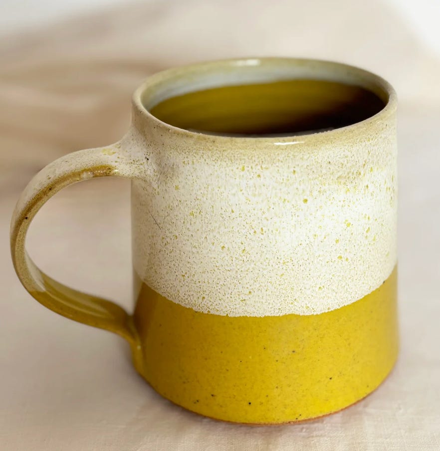 cream and yellow glazed ceramic mug