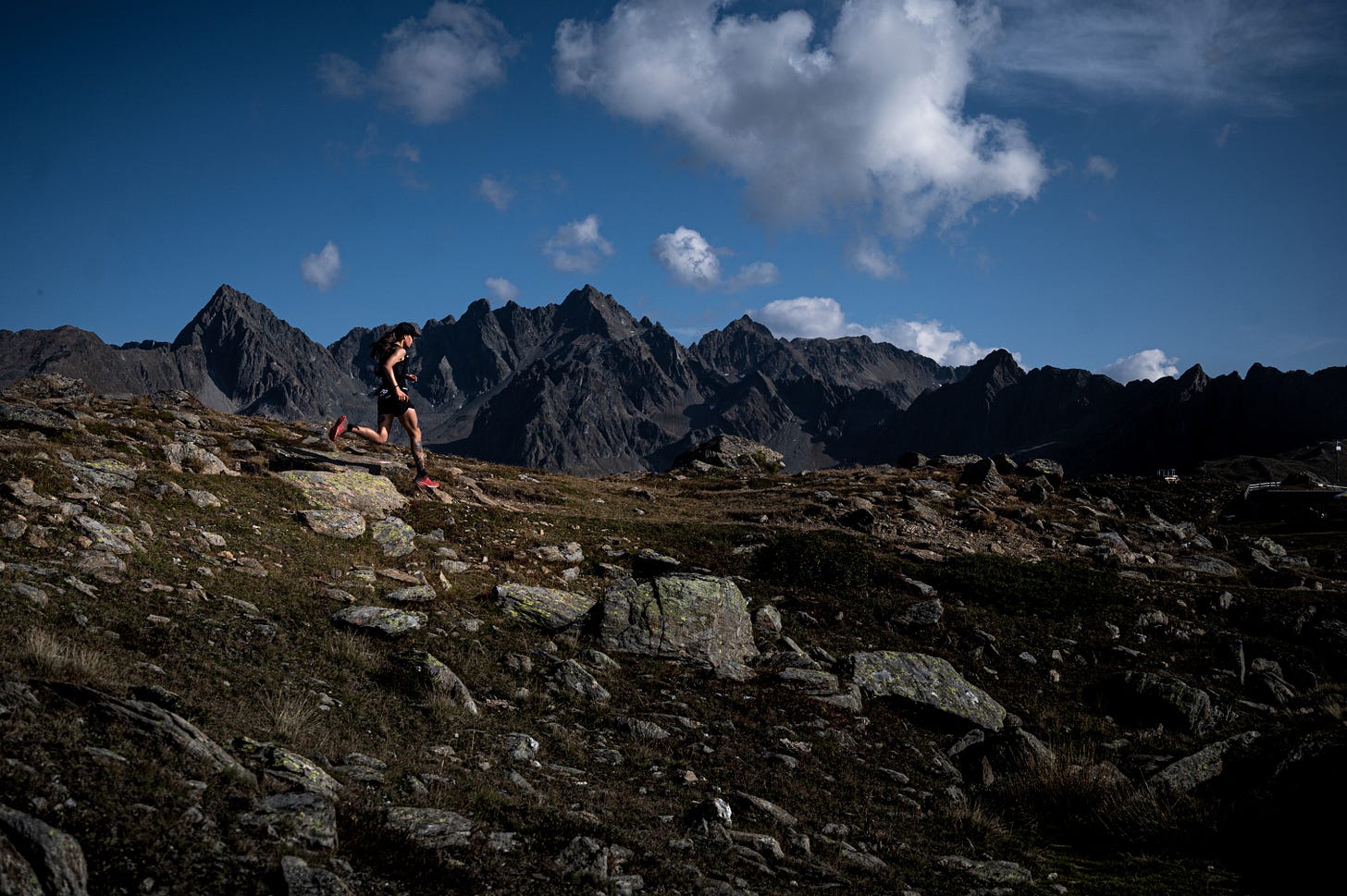 Female runner running on a mountain ridge