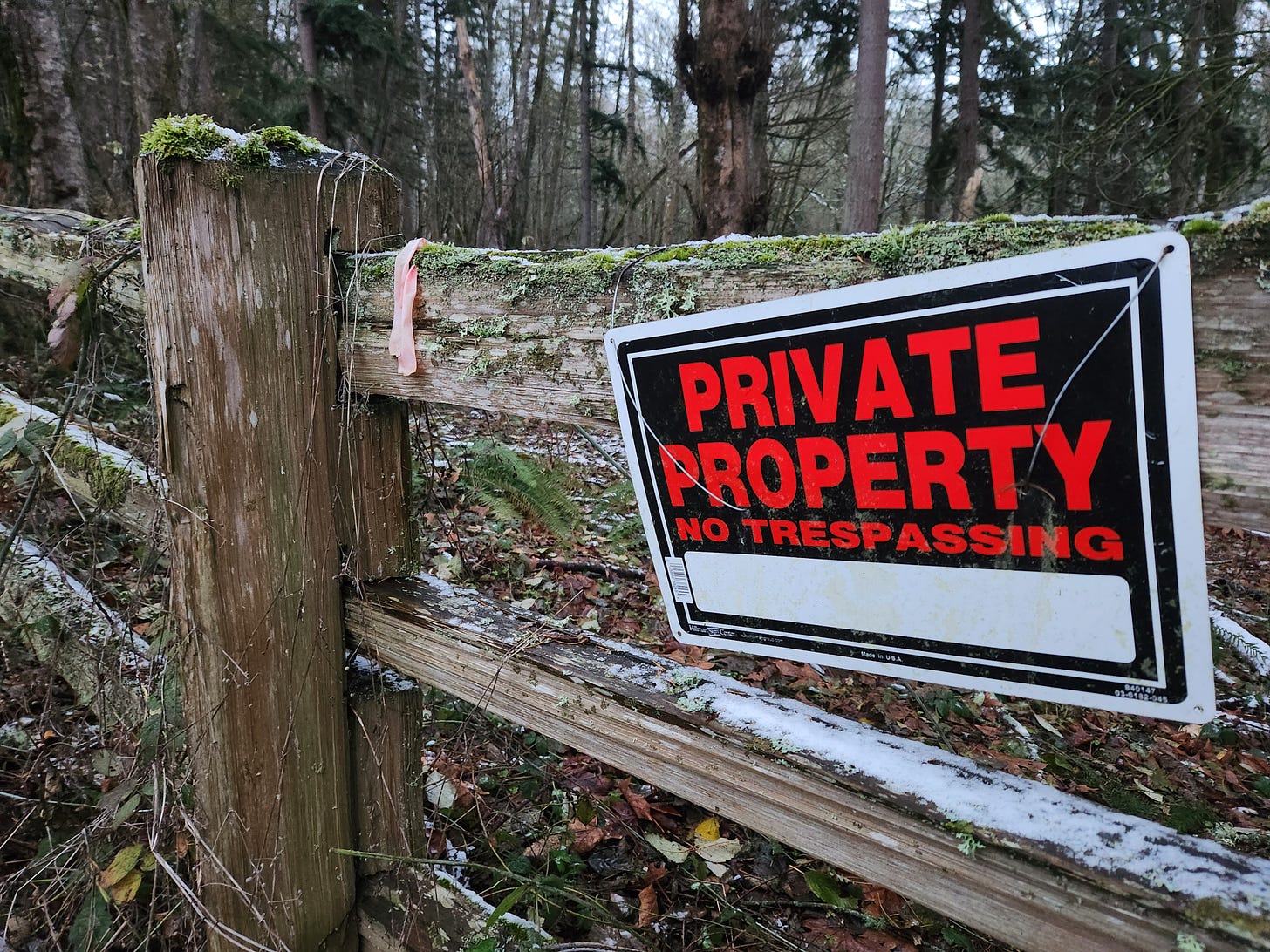 a private property no trespassing sign on a wooden fence