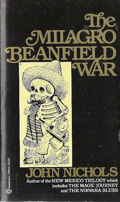 Cover of paperback edition of John Nichols' best known novel, The Milagro Beanfield War. It features a drawing of a skeleton dressed in sombrero, serape, loose pants and sandals, carrying a bottle of wine.