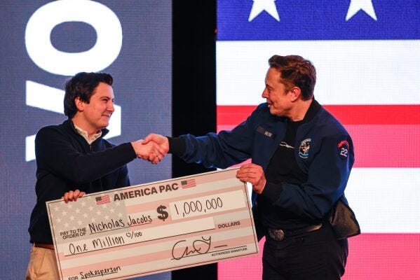 Elon Musk presents a check for $1 million dollars to a man during a town hall Sunday, March 30, 2025, in Green Bay, Wis. (AP Photo/Jeffrey Phelps) Elon Musk presents a check for $1 million dollars to a man during a town hall Sunday, March 30, 2025, in Green Bay, Wis. (AP Photo/Jeffrey Phelps)