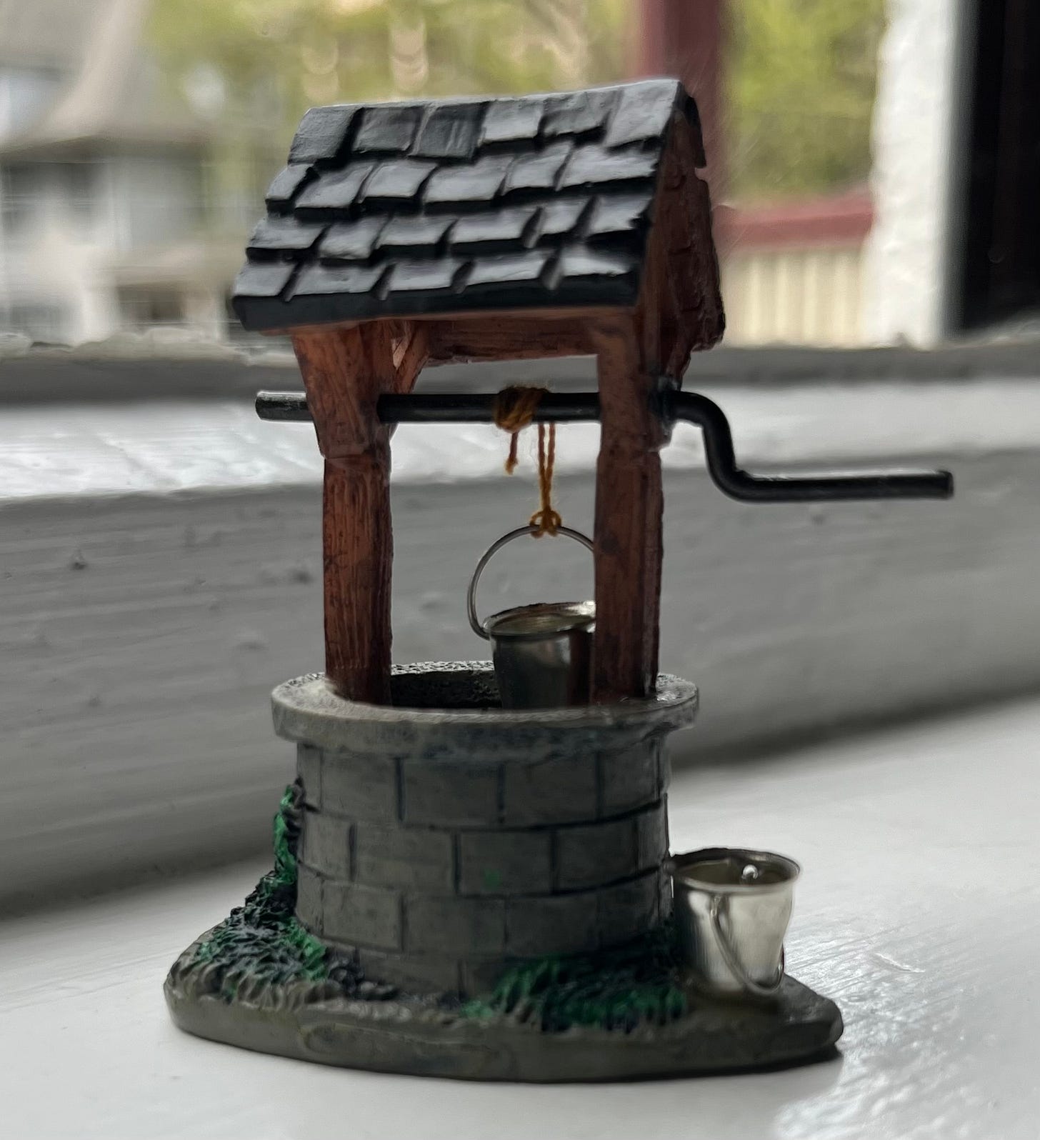 closeup of a tiny, toy wishing well closeup of a tiny, toy wishing well