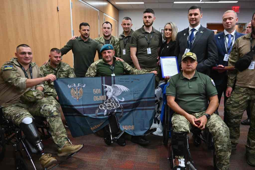 Ukrainian President Volodymyr Zelensky stands for a photo while visiting with wounded Ukrainian soldiers at the Staten Island University Hospital.