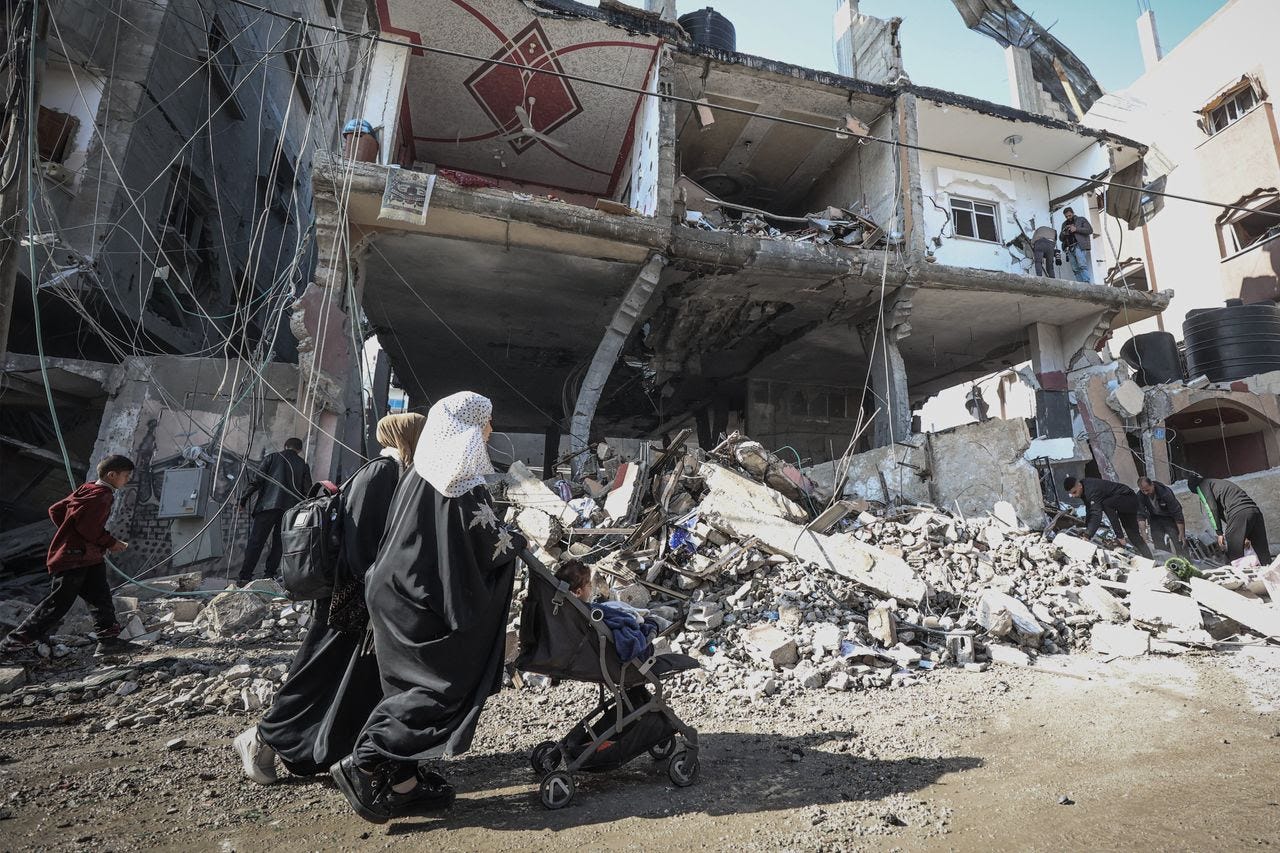 People walk in Gaza on Feb. 24. (Loay Ayyoub for The Washington Post)
