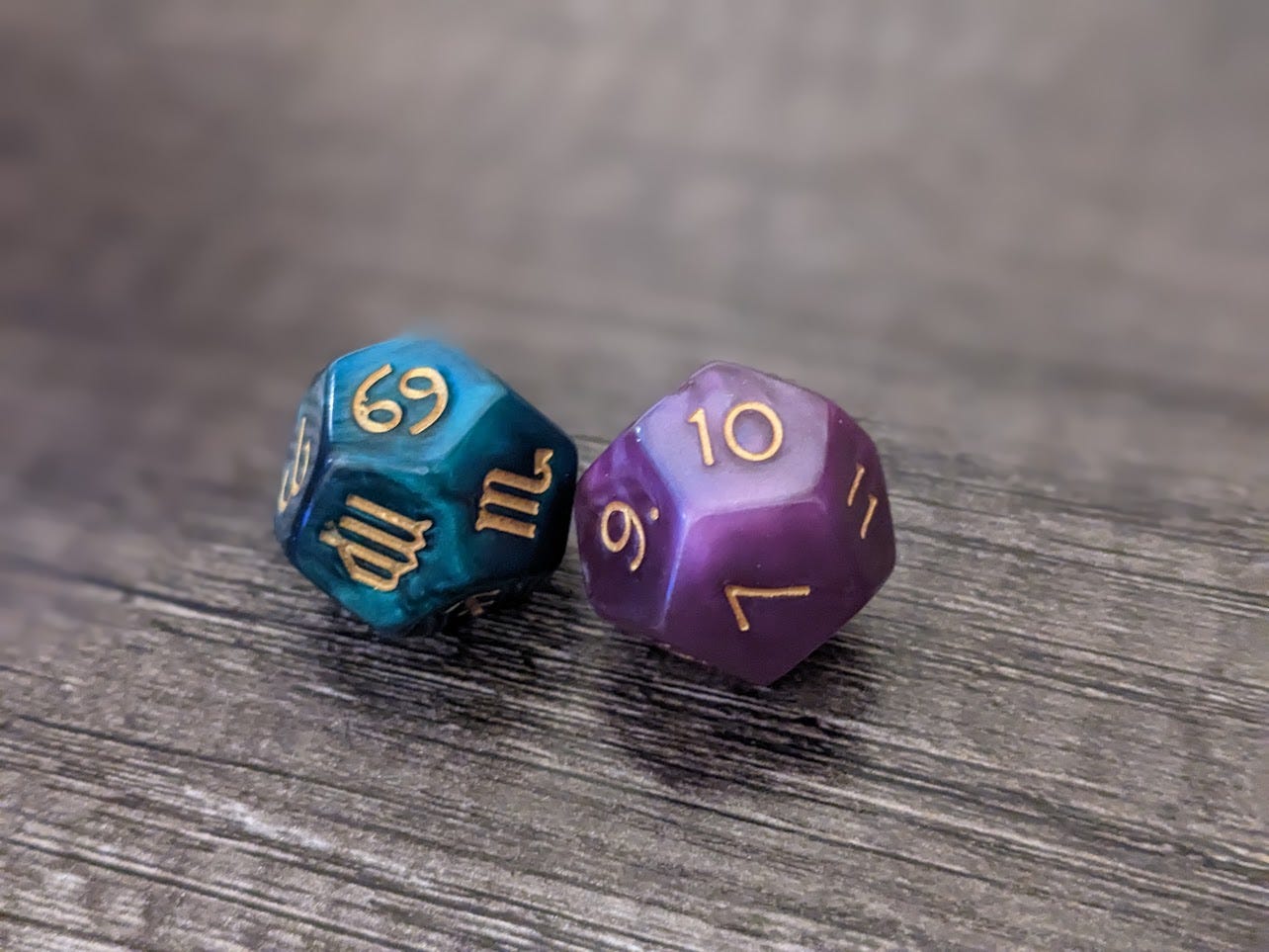 Photograph of two astro dice, one showing the sign Cancer, and the other the 10th house