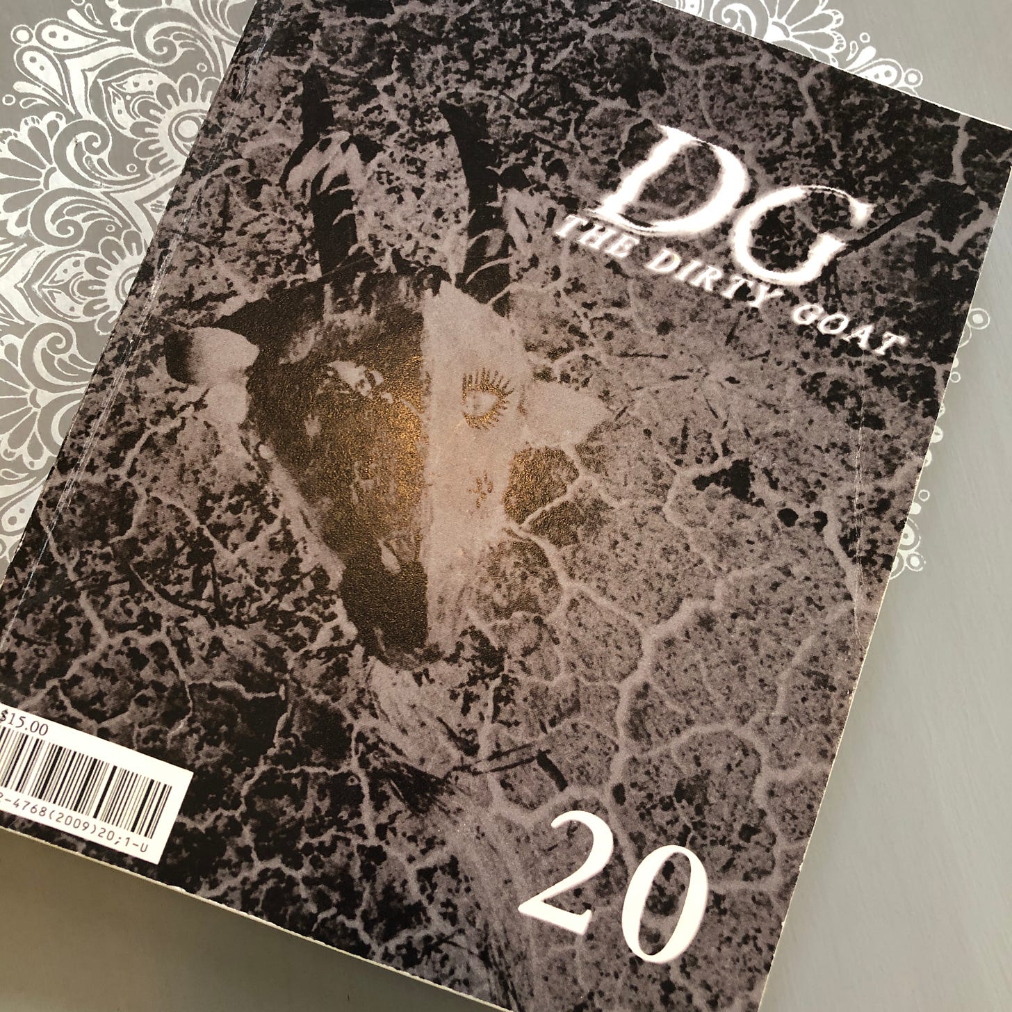 Cover of journal on a table with the words: DG, The Dirty Goat, 20