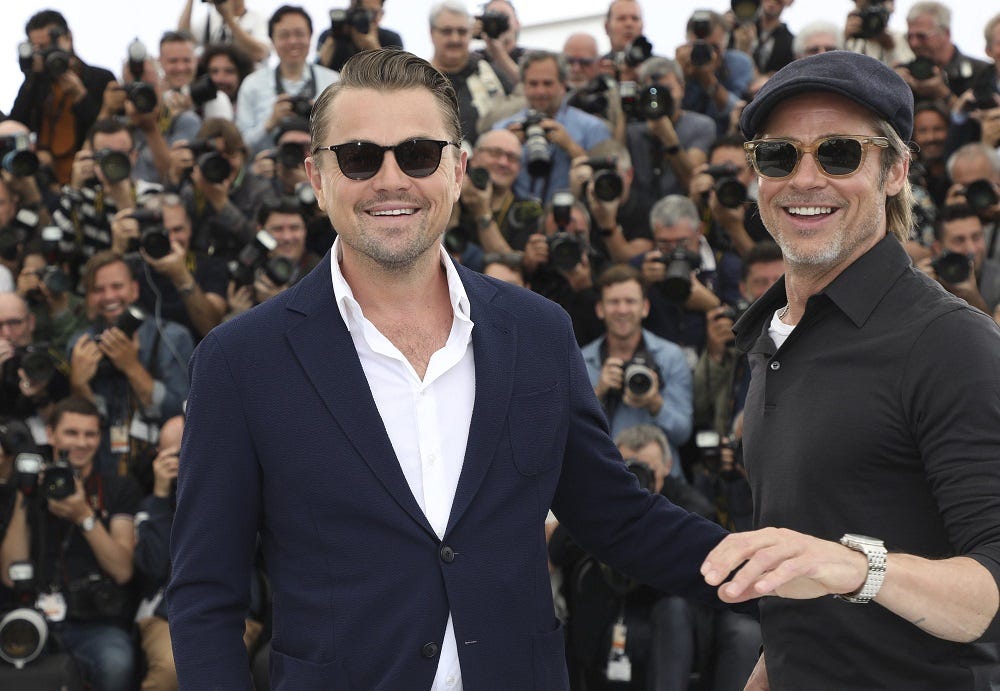 leonardo dicaprio smiles with brad pitt at cannes once upon a time