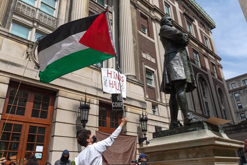 Pro-Palestinian student protestors wave a Palestinian flag as they gather on the front steps of Hamilton Hall at Columbia University in New York City on April 30, 2024.