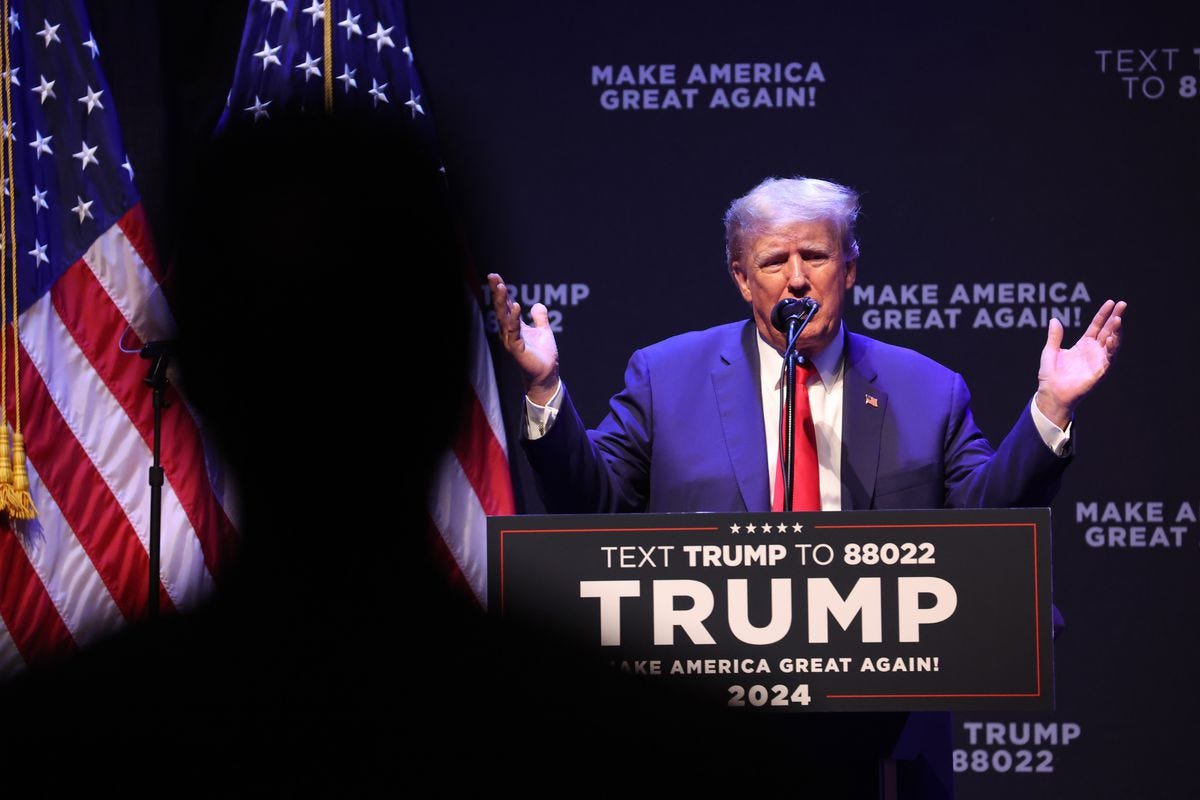 Trump speaks from behind a podium.