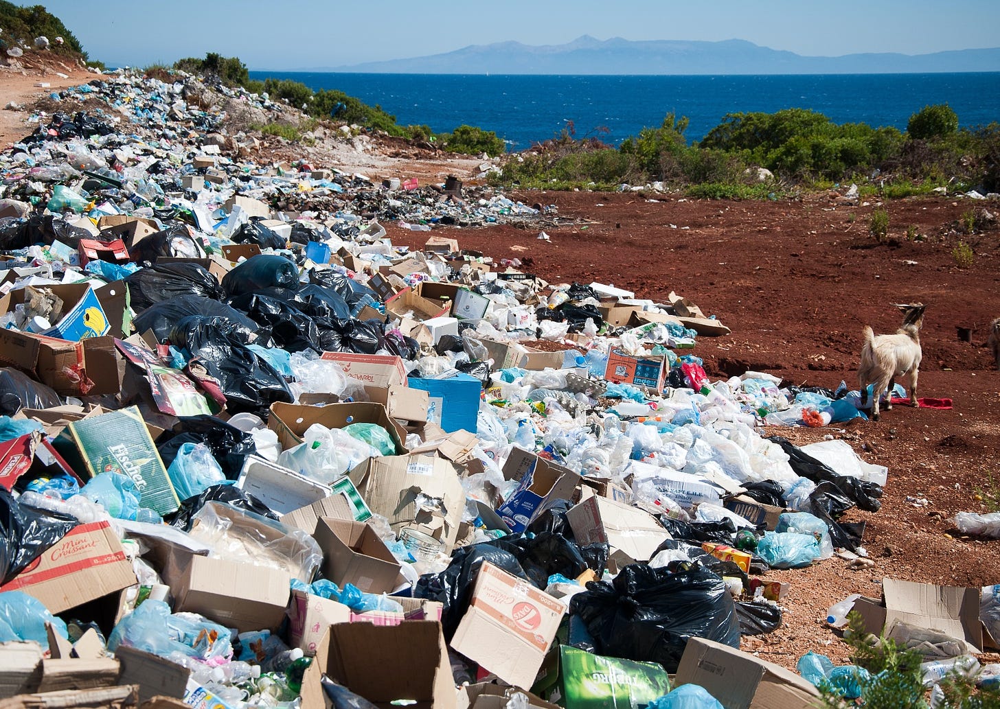 huge piles of plastic pollution in a coastal landscape