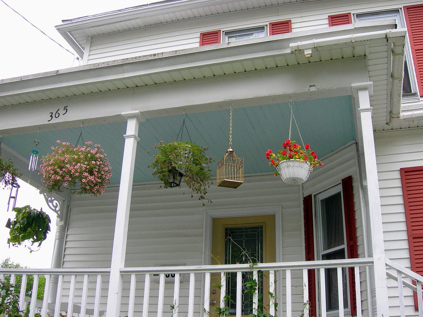 A porch with haint blue painted ceilings.