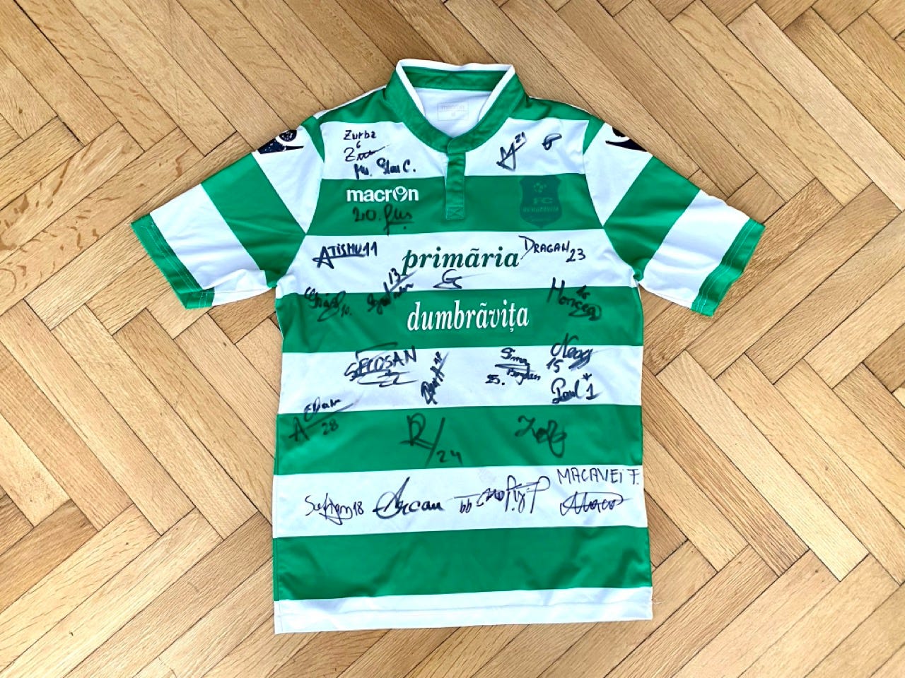 A photograph of a football shirt from CSC Dumbrăvița, with signatures from the players.