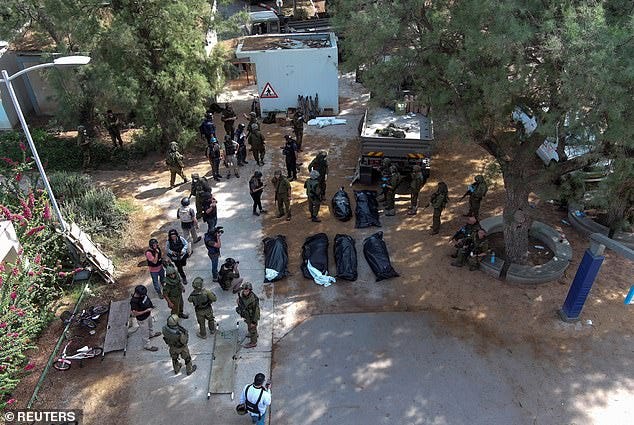 An aerial view shows the bodies of victims of the Hamas attack on the Kfar Aza Kibbutz on Tuesday