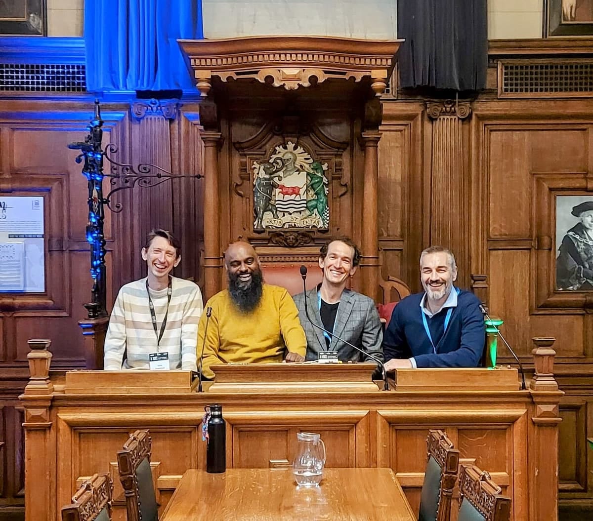 Photograph of the speakers sitting at the front of the Oxford Town Hall assembly rooms