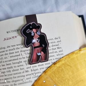 a bookmark that depicts a faceless Beyoncé figurine from the promo for Cowboy Carter