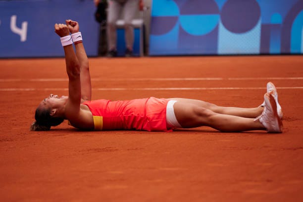 Qinwen Zheng of Team People’s Republic of China celebrates after winning match point during the Tennis Women's Singles Gold Medal match against Donna...