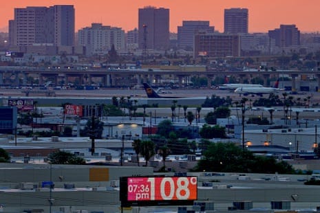 A billboard showing a temperature reading of 108F at 7.36pm in Phoenix.
