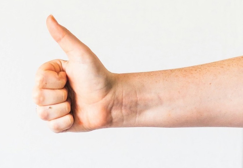 persons right hand doing thumbs up persons right hand doing thumbs up