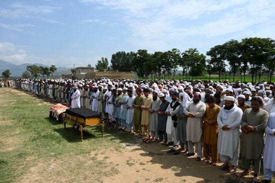 People attend a funeral for bomb blast victims in Pakistan.