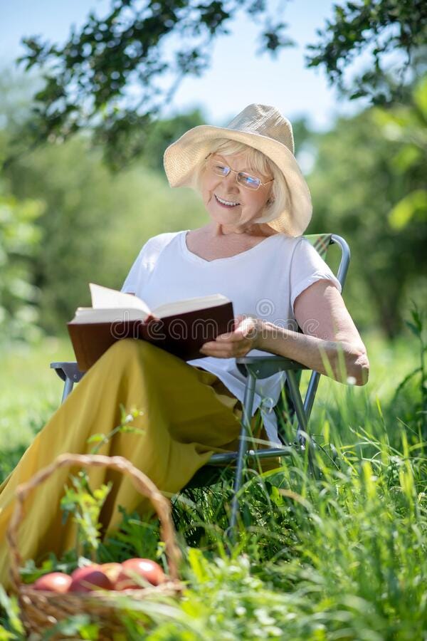 Smiling Elderly Woman Enjoying Reading a Book in the Garden Stock Photo -  Image of peaceful, outdoors: 191775740