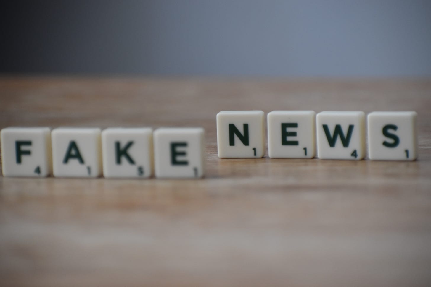 the words Fake News spelled out in scrabble tiles. 