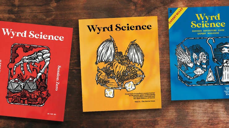 3 issues of Wyrd Science magazine laid out on a wooden table