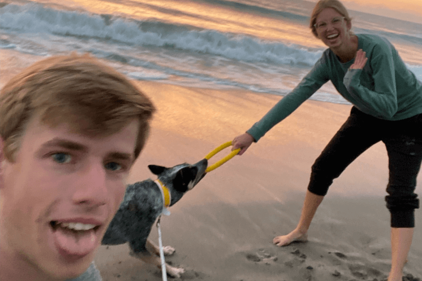 A selfie taken by Scout's owner Sean while the Australian cattle dog plays tug on the dog-friendly stretch of Cocoa Beach with her other owner Haley