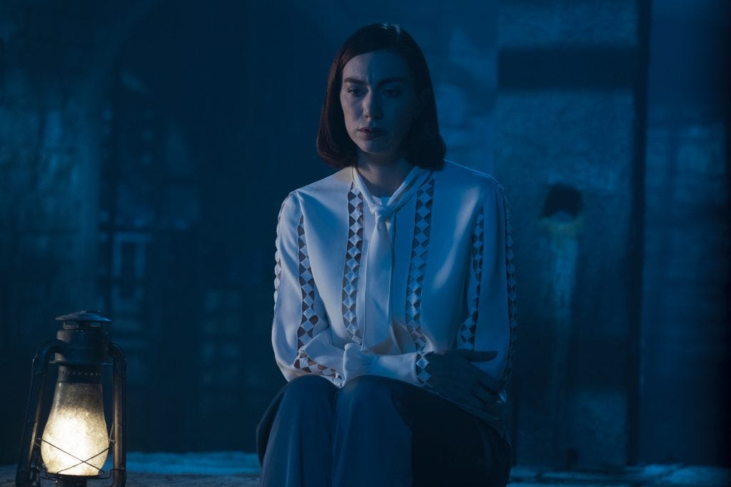 This photo shows Yvette Picard (played by Madeline Wise) sitting in Château Picard's basement while looking downward and contemplating her own emotions. A lantern sits on her right (and on the image's left). This photo shows Yvette Picard (played by Madeline Wise) sitting in Château Picard's basement while looking downward and contemplating her own emotions. A lantern sits on her right (and on the image's left).