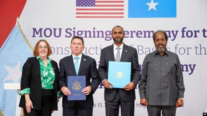 U.S. Assistant Secretary of State for African Affairs Molly Phee, Charge d'Affaires to the U.S. Embassy Shane Dixon, Defense Minister Abdulkadir Mohamed Nur and President Hassan Sheikh Mohamud attend the signing of a security pact in Mogadishu, Somalia, on Feb 15, 2024.