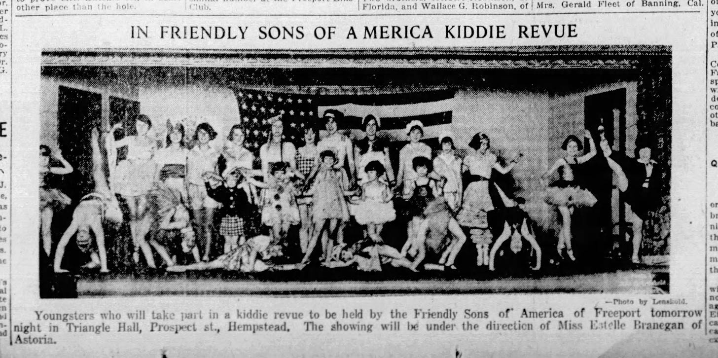 Image is a photograph of approximately twenty girls in various poses in front of an American flag. The headline reads: "In Friendly Sons of America Kiddie Revue"