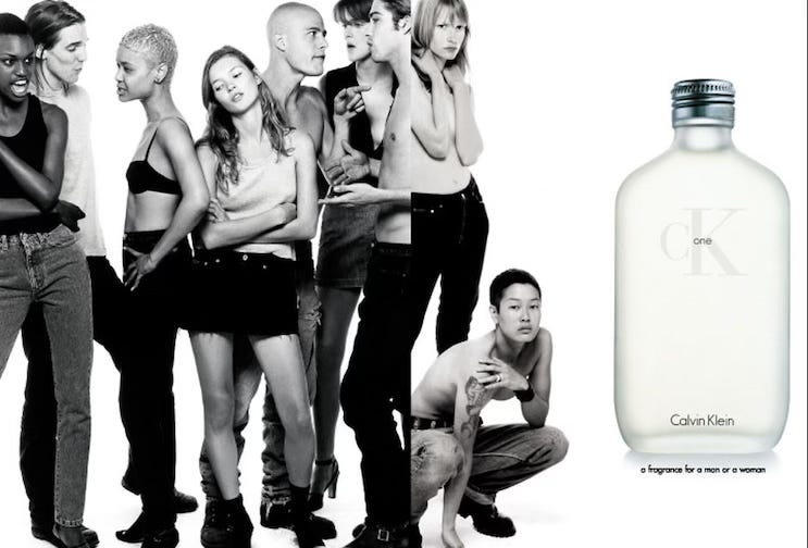 An advert for CK One fragrance from 1994, which features a group of models standing talking next to a large bottle of CK One and in the middle of them is Kate Moss looking peed off