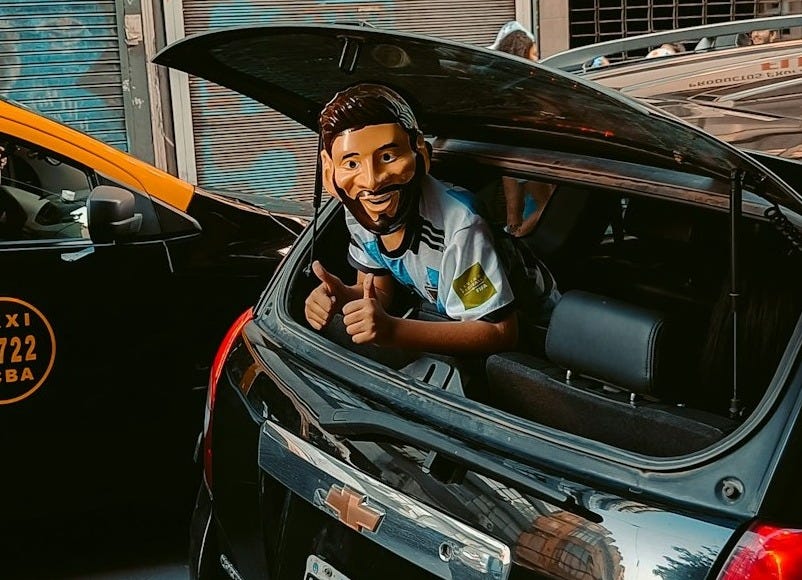a man driving a car on a city street a man driving a car on a city street