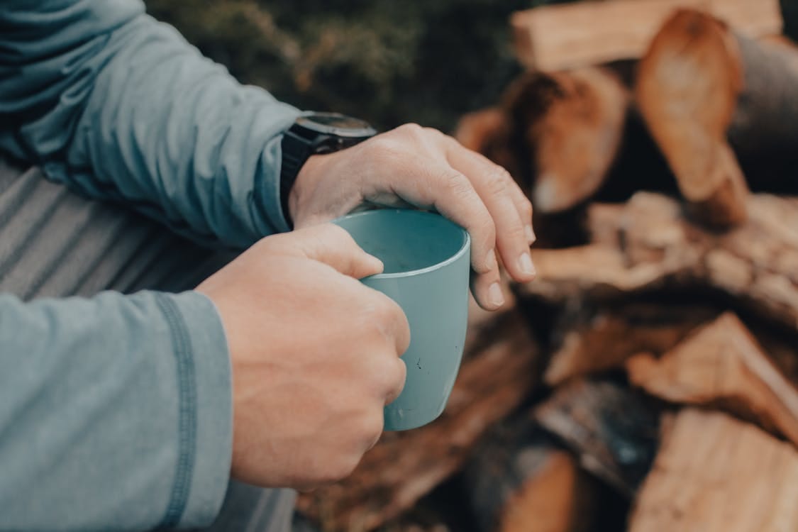 Free Person Holding a Blue Mug Stock Photo