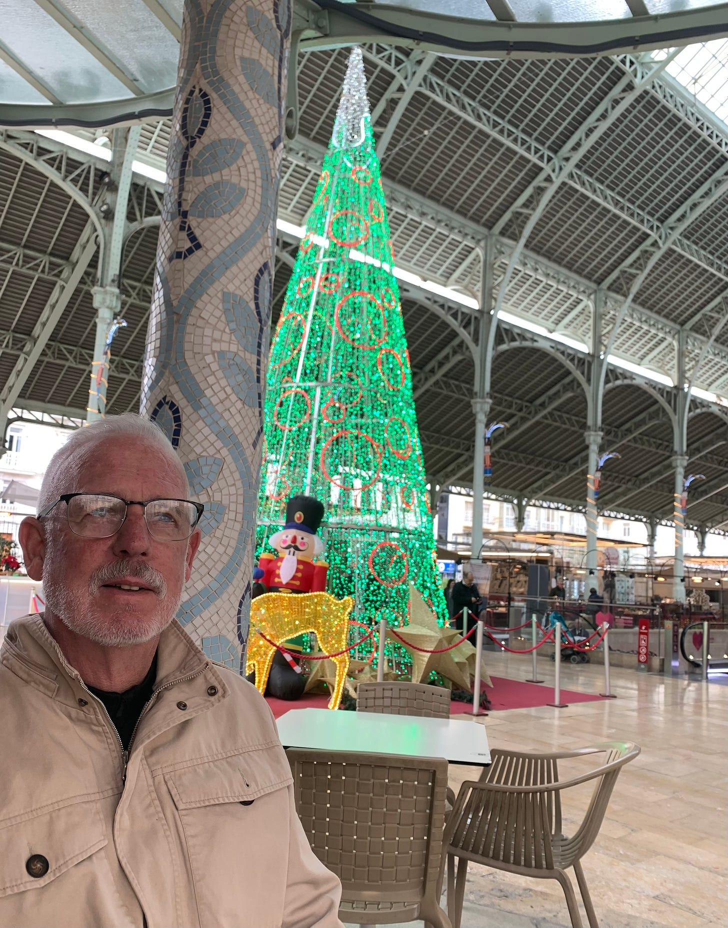 The main level of Colon Market has nutcrackers and lights on each column and a big Christmas tree made of lights in the center.