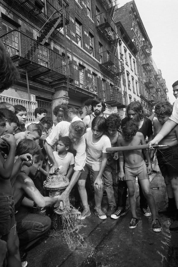 Mayor John Lindsay adjusting a cap on a hydrant in Williamsburg. Aug. 31, 1973.