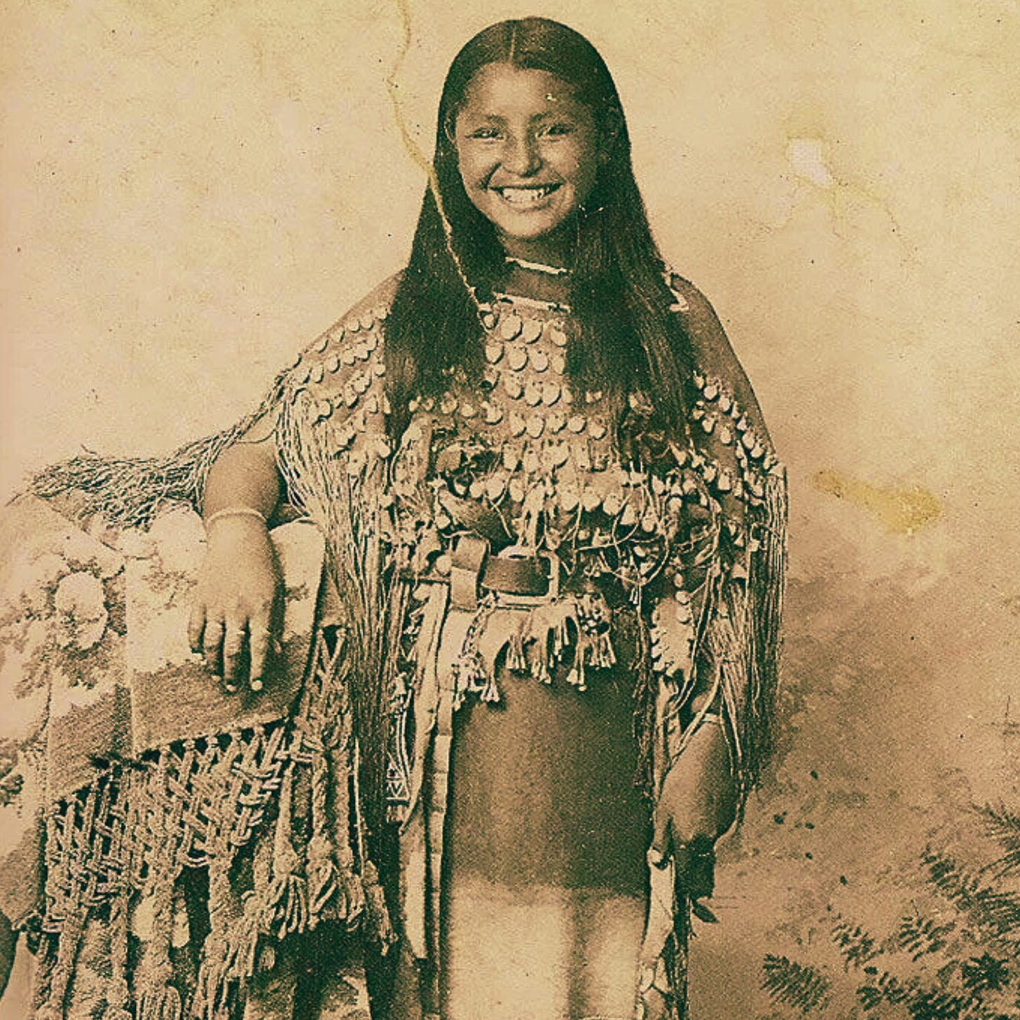 Photo of a smiling Kiowa girl, circa 1895