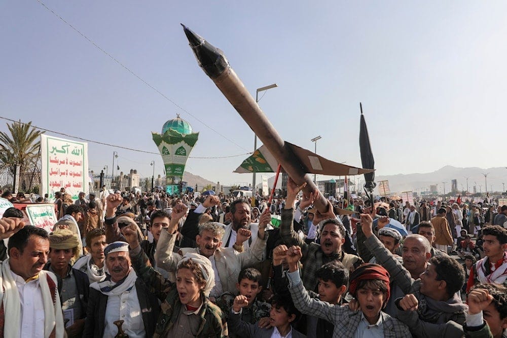 Yemeni demonstrators carry a mock rocket and chant slogans during an anti-Israeli occupation rally in Sanaa, Yemen, Friday, Dec. 27, 2024 (AP)