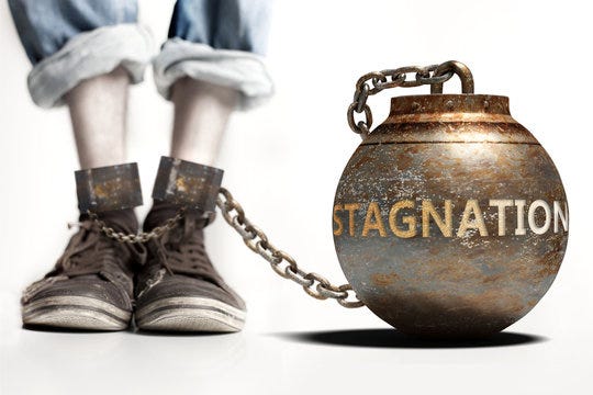 Stagnation can be a big weight and a burden with negative influence -  Stagnation role and impact symbolized by a heavy prisoner's weight attached  to a person, 3d illustration Stock Illustration |
