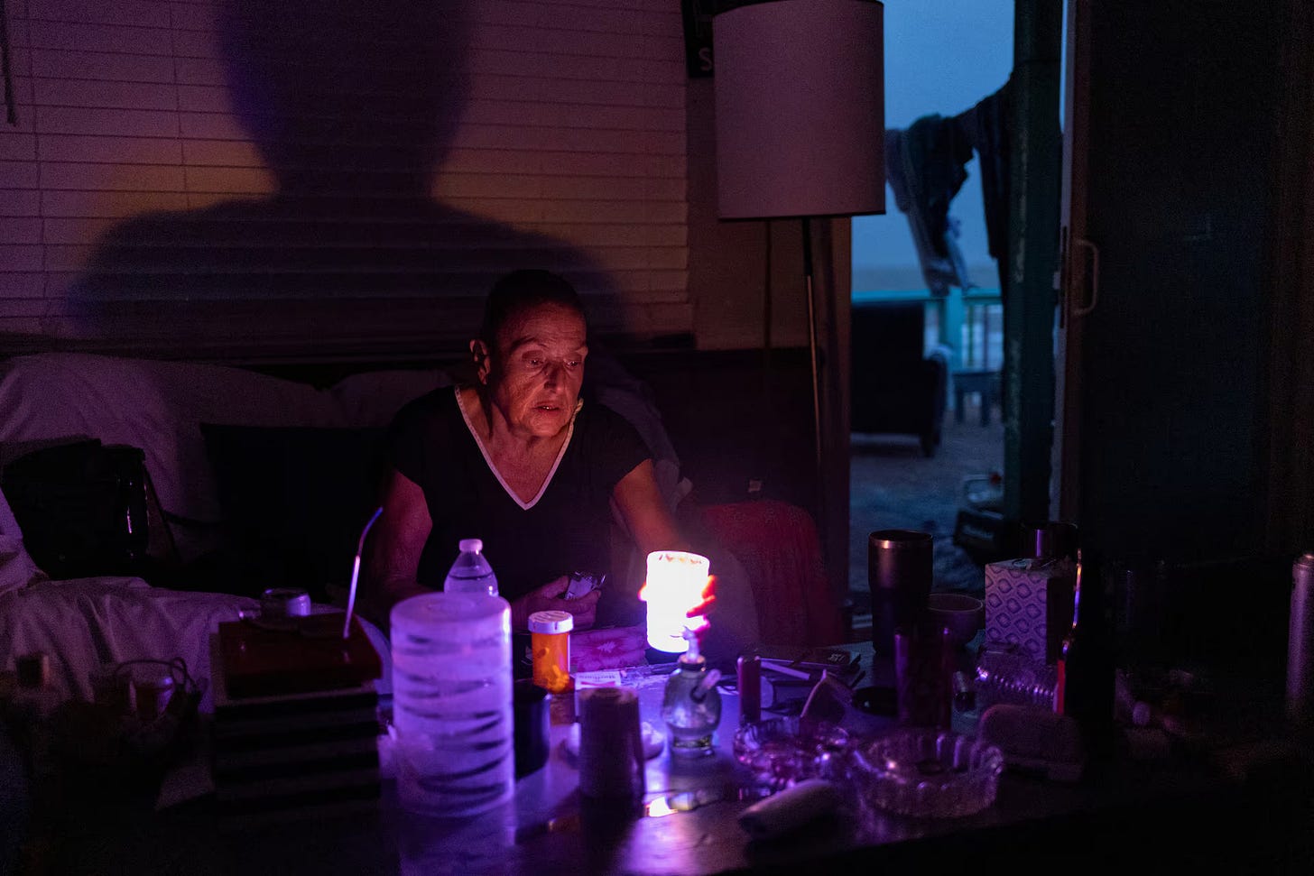 A woman lights a candle in a dark room after losing electricity as a result of impacts from Hurricane Beryl in Surfside Beach, Texas, US.