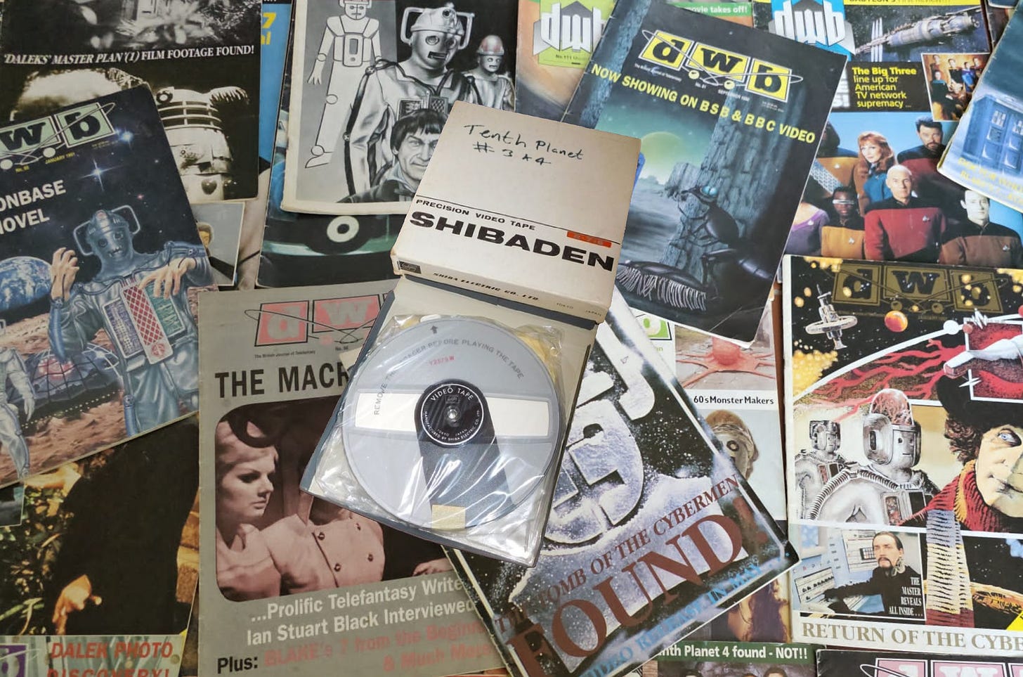 A Shibaden videotape labelled as containing the last two episodes of The Tenth Planet sat upon a bed of early 1990s fanzines (mainly DWB), in a slightly shoddy photo-montage