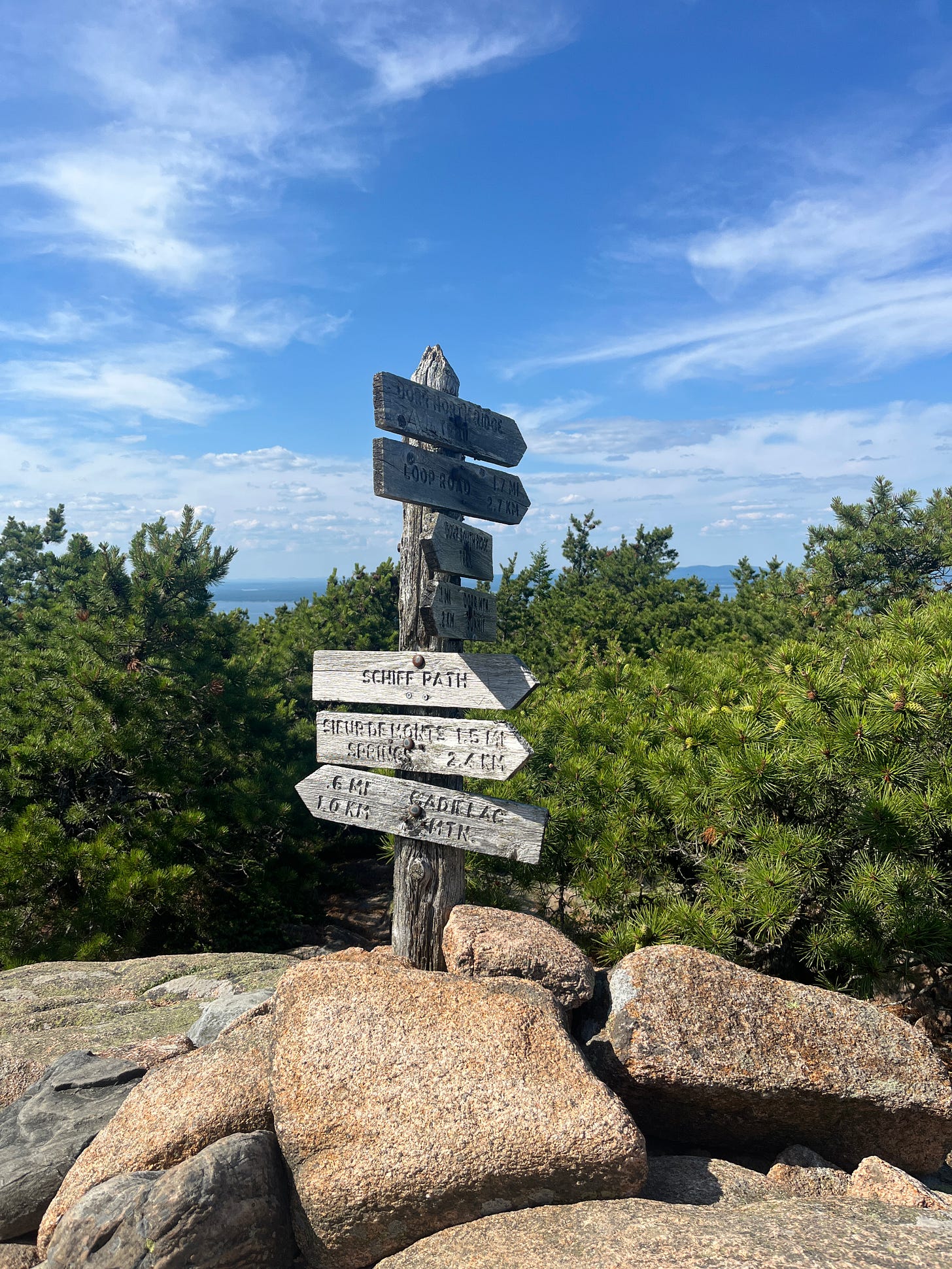 Mountain Trail head in Acadia Park with a blue sky behind it.