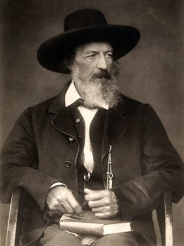 This may contain: an old photo of a man with a long beard wearing a hat and sitting in a chair