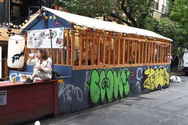 Graffiti on outdoor dining structures in the East Village make the impromptu setups even uglier.