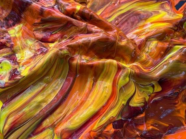 An abstract image of swirling red, orange, and yellow colors