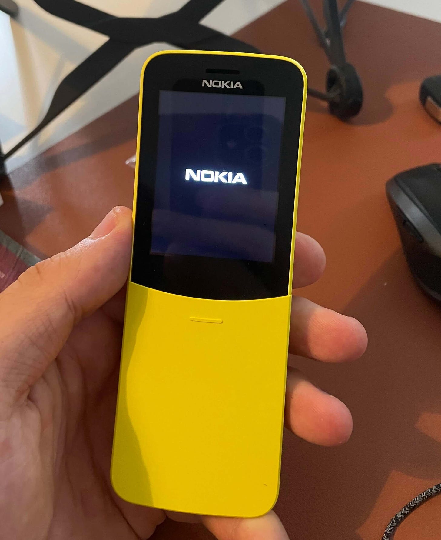 A yellow nokia mobile phone with a curved shape