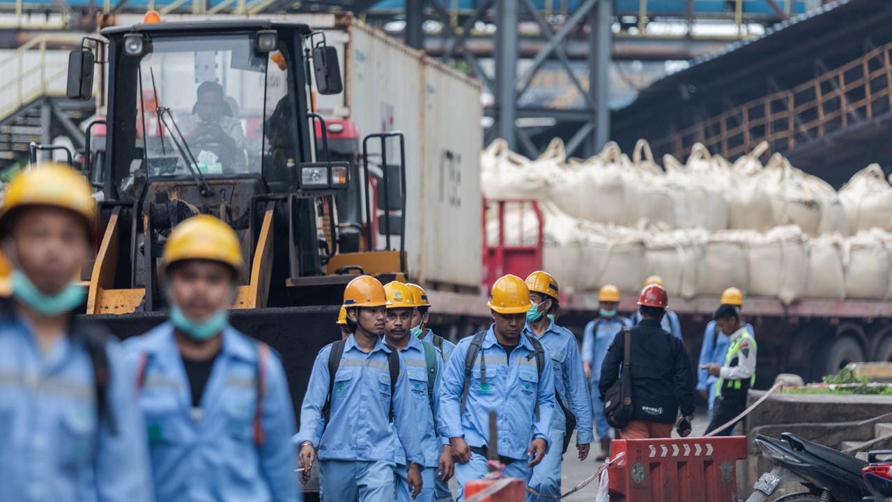 Employees during the working shift change near Indonesia Morowali Industrial Park. Picture: Garry Lotulung