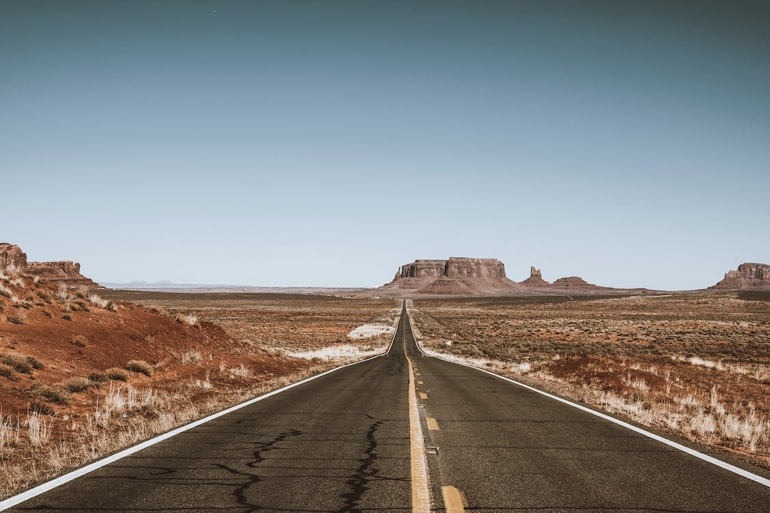 Free Empty Road Crossing Monument Valley, Utah, USA Stock Photo